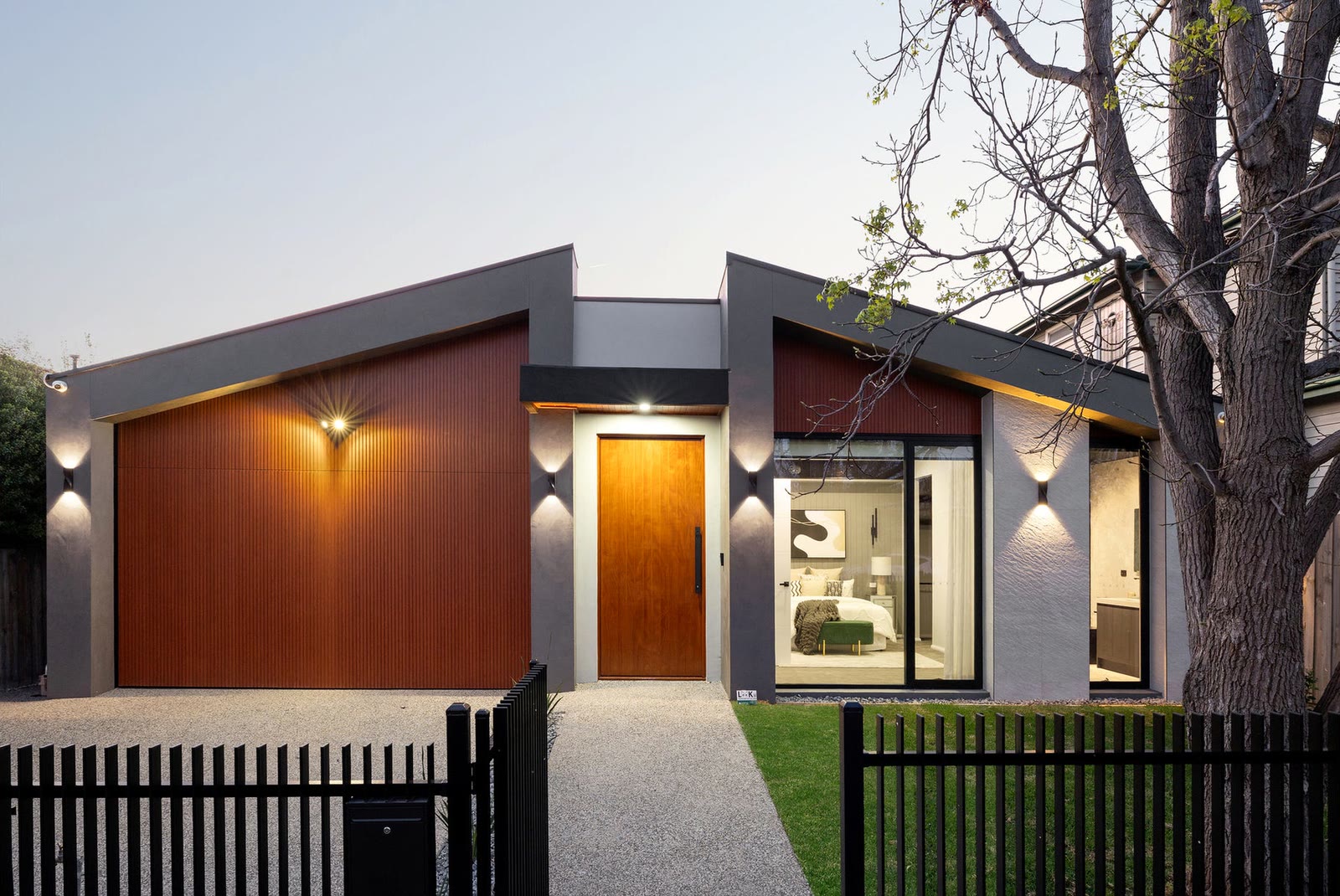 Lincoln Road, Essendon. The street facade of a completed home in Essendon, lit at dusk.