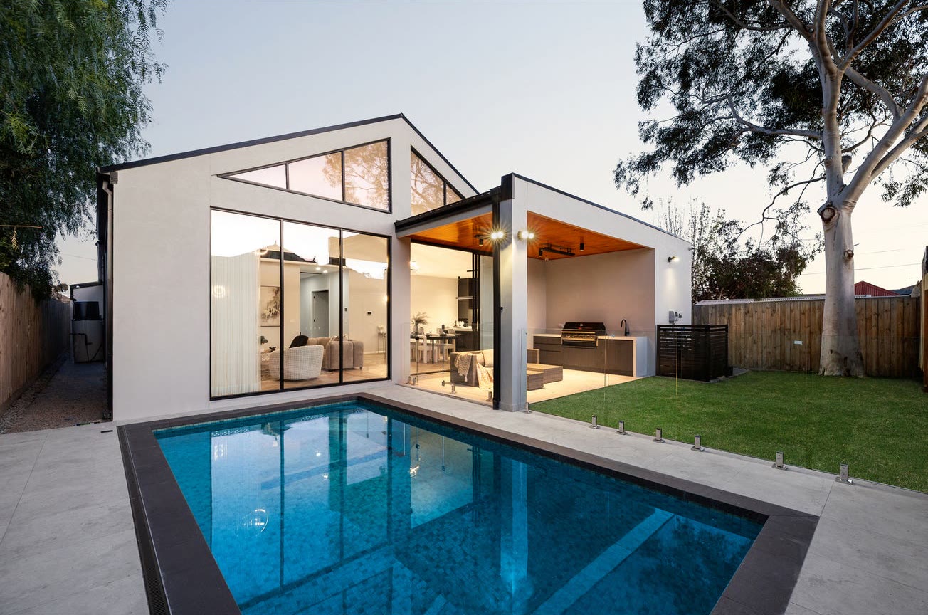 A pool and outdoor living area at dusk, from the completed Lincoln Road project in Essendon.