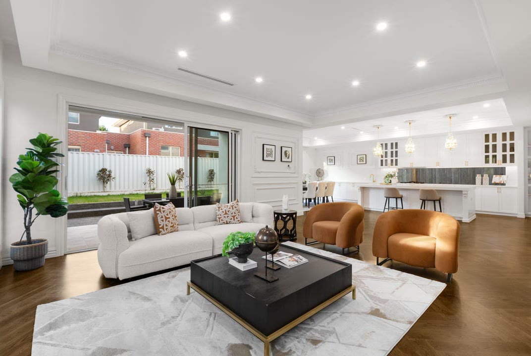 A finished open plan living space opening to a courtyard, from a completed project in Altona North.